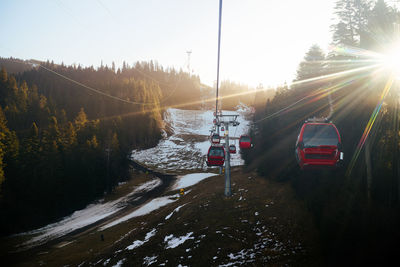 Cable car in mountains against sunny sky