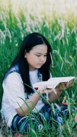 Beautiful young woman lying on field