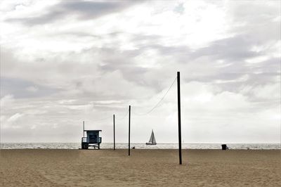 View of lifeguard hut at beach against sky