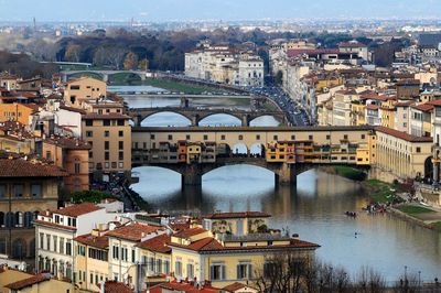 High angle view of bridges over river amidst buildings in city