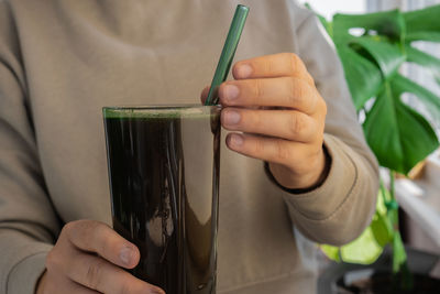 Midsection of woman holding drink