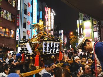 Crowd on street in city at night