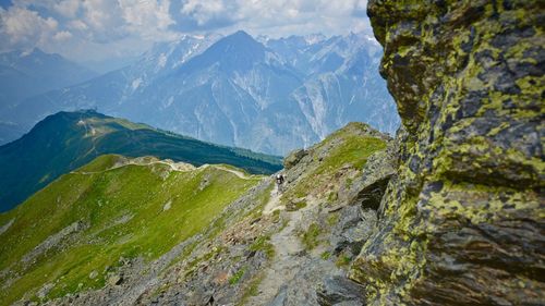 Scenic view of mountains against cloudy sky