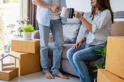Young woman using mobile phone in box