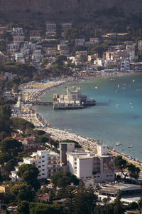 High angle view of sea and buildings in city