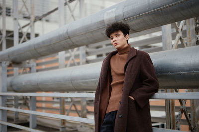 Portrait of young woman standing in city