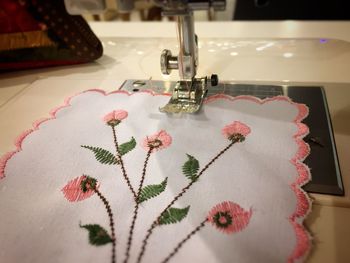Close-up of floral pattern napkin on sewing machine