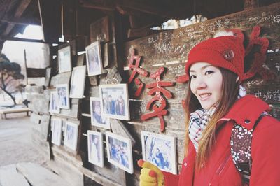 Portrait of smiling young woman standing in store