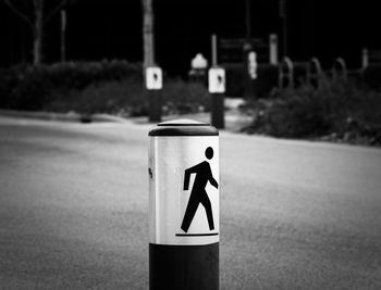 Close-up of arrow sign on street