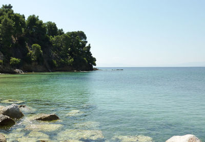 Surface level of calm sea against clear sky