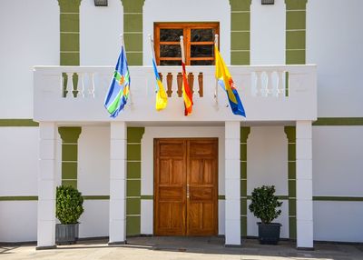 Multi colored flags hanging on wall