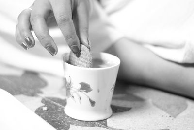 Midsection of woman holding coffee cup