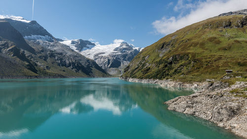 Scenic view of lake and mountains against sky