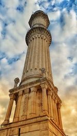 Low angle view of tower against cloudy sky