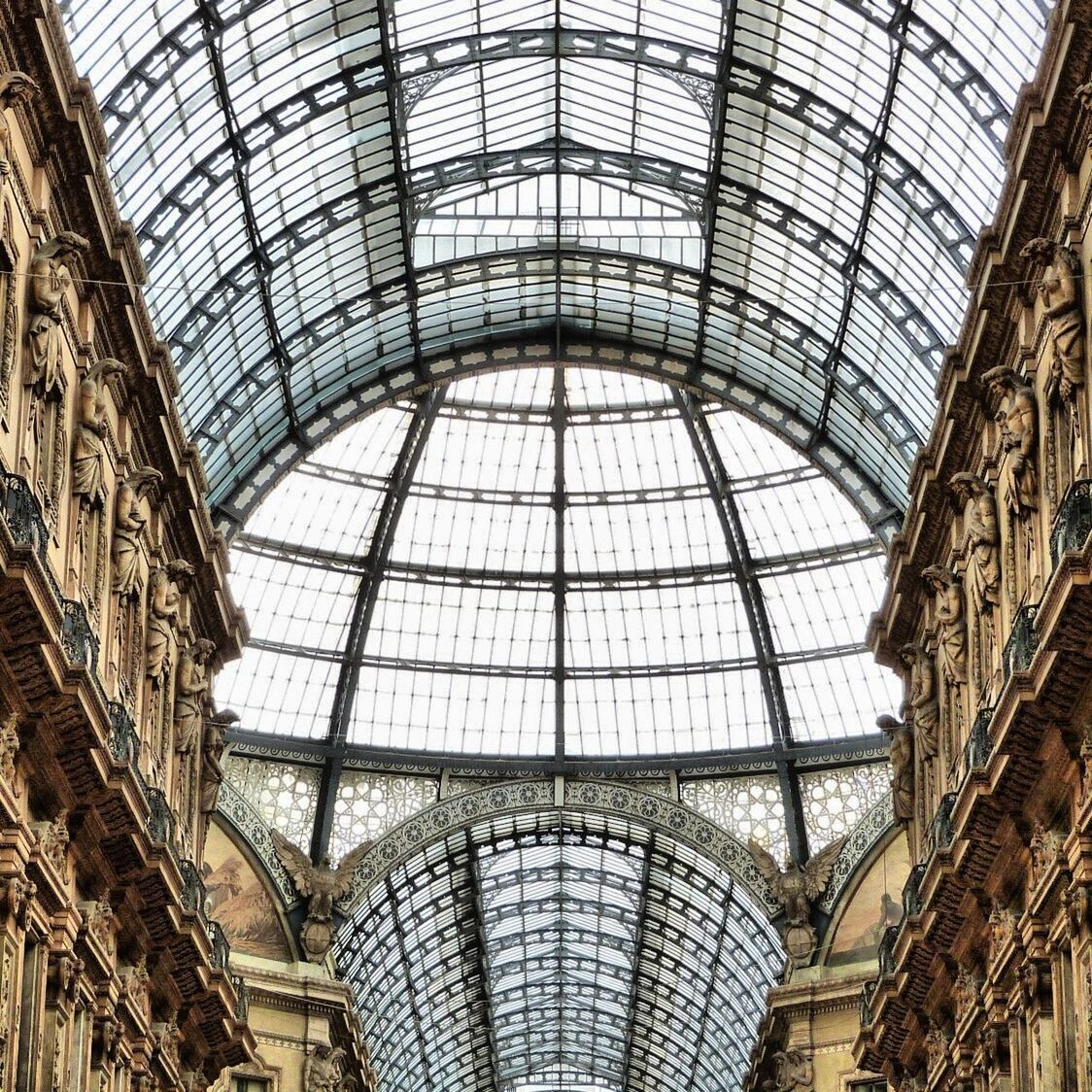 indoors, ceiling, architecture, built structure, skylight, glass - material, pattern, low angle view, architectural feature, interior, design, directly below, modern, window, transparent, day, full frame, no people, shopping mall, famous place