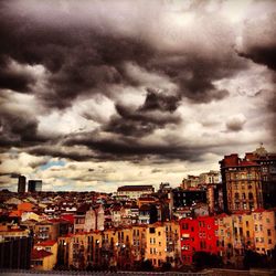 Buildings against cloudy sky