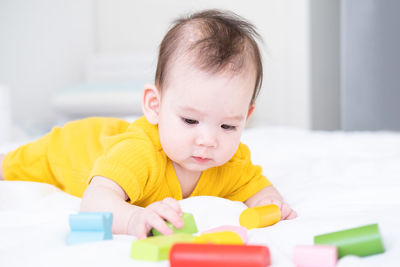 Close-up of cute boy playing with pills