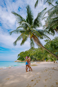 Full length of young man on beach against sky