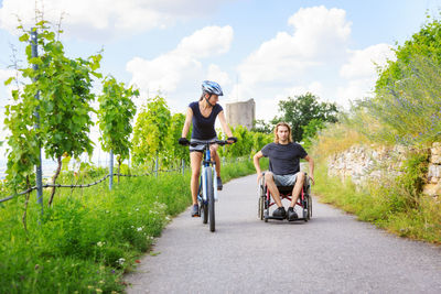 Women riding bicycle on plants