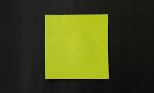 Close-up of yellow paper against black background