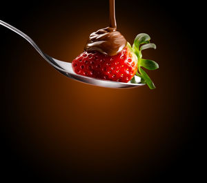 High angle view of strawberries on plate against black background