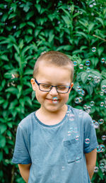 Portrait of young man against plants