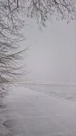 Scenic view of frozen landscape against sky during winter