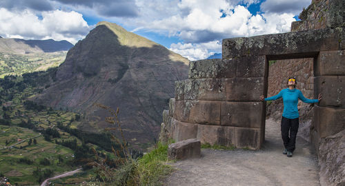 Woman exploring inca ruins above ollantaytambo, peru