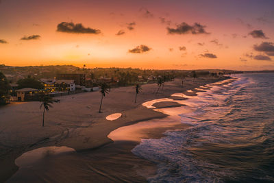 Scenic view of beach against sky during sunset