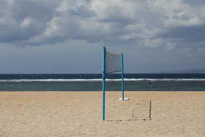 Lifeguard hut on beach against sky