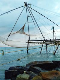 Sailboats moored on beach against sky