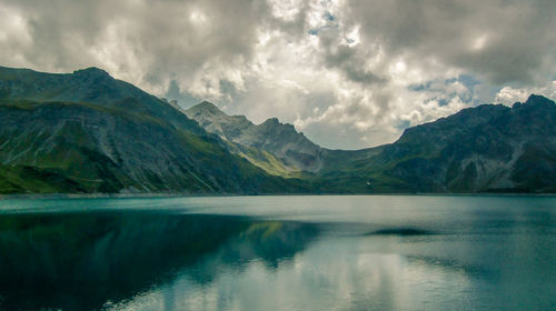 Scenic view of lake and mountains against sky