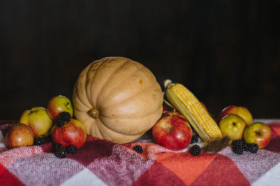 Close-up of fruits on table against black background