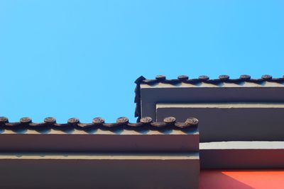 Low angle view of built structure against clear blue sky