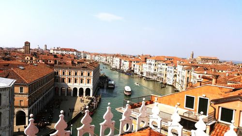 High angle view of canal in city against sky