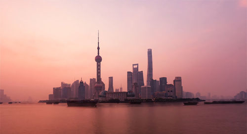 Modern buildings in city at sunset