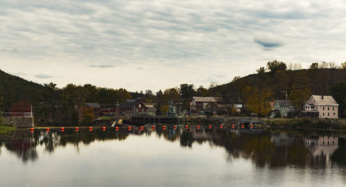 Reflection of buildings in lake against sky