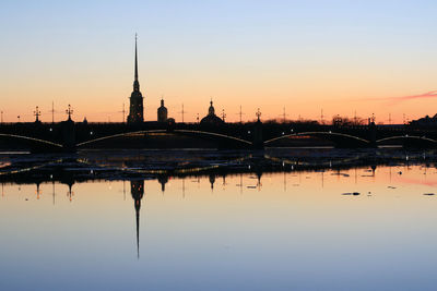 Bridge over river against sky during sunset