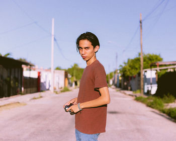 Portrait of young man standing on street