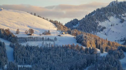 Snow covered land and mountains against sky