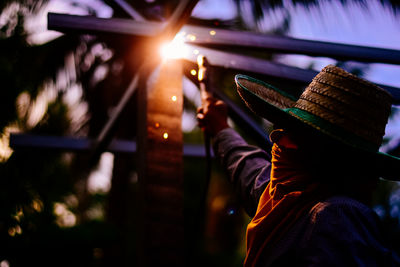 Young man wearing hat working outdoors