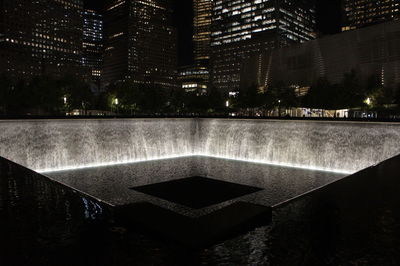 Fountain in city at night