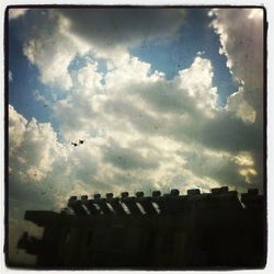 Low angle view of built structure against cloudy sky