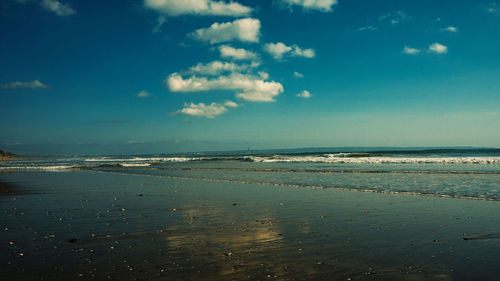 Scenic view of sea against blue sky