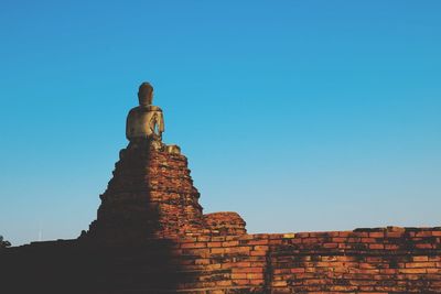 Low angle view of statue against clear blue sky