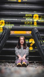 Portrait of smiling woman sitting on seat