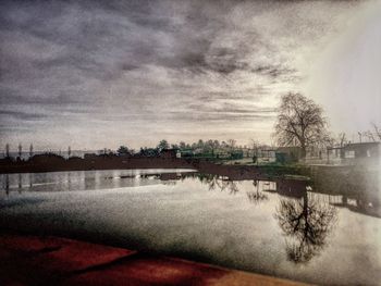 Scenic view of lake against cloudy sky