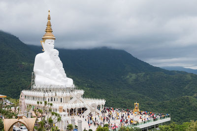 Temple by building against sky