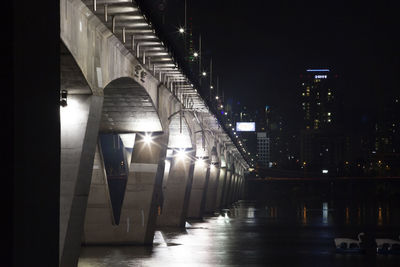 Illuminated wonhyo bridge over han river by cityscape at night