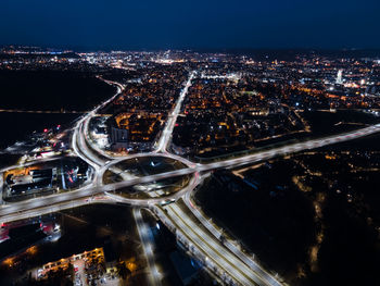 High angle view of illuminated city against sky at night